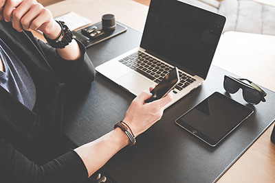 Woman on phone using laptop